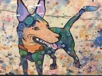 a painting of a colorful dog on a wall